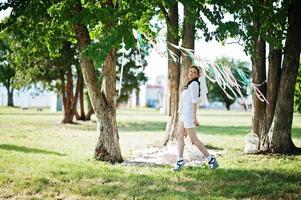 Unmarried girl with veil on had posed background picnic table and decor at bachelorette party photo