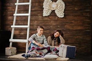 Young fashion winter  couple at wooden background photo