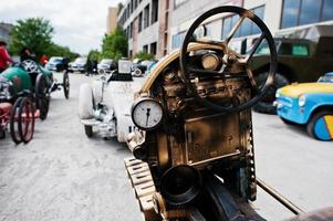 Iron handmade steering wheel at vintage sport car photo