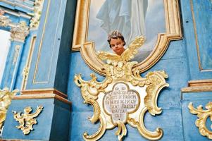 Golden statue of head angel at iconostasis of church photo