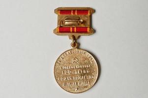 Soviet medal for the valiant work 100 anniversary of Lenin's birth on white background photo