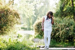 African woman at national white clothes and sunglasses photo