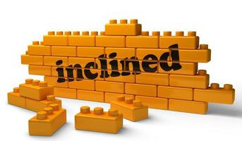inclined word on yellow brick wall photo