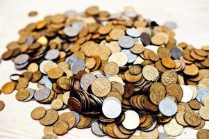 Mountain coins on wooden background photo