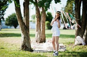 Unmarried girl with veil on had posed background picnic table and decor at bachelorette party photo