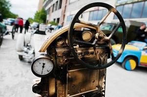 Iron handmade steering wheel at vintage sport car photo