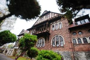 Old abandoned brick  mystic mansion. Gothic building at autumn photo