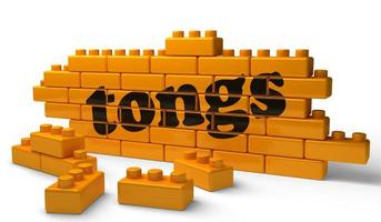 tongs word on yellow brick wall photo