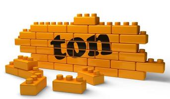 ton word on yellow brick wall photo