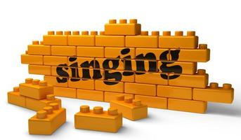 singing word on yellow brick wall photo