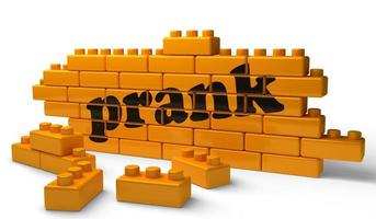 prank word on yellow brick wall photo