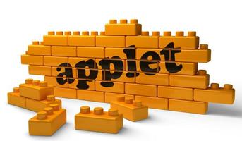 applet word on yellow brick wall photo