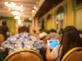 Abstract blurred photo of conference hall or seminar room with attendee background