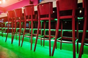 Red bar stools at diode color light photo