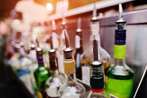 Close up bottles of alcohol and liquor at the bar photo