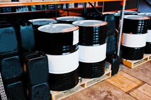 Barrels and cans of motor oil on shelves photo