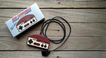 BANGKOK, THAILAND - April 10, 2019. Old Hori Controller on wooden background. photo