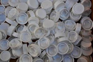 Many white plastic bottle caps photo