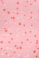 Flying hearts on a pink background. Festive backdrop. photo