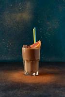 Iced coffee with milk and cinnamon in a transparent glass cup photo