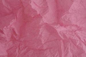 Textured crumpled pink silk paper. Macro shot. photo