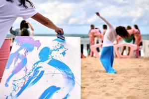 Drip painting outdoor art performance with dancing girls, creative workshop, art festival photo