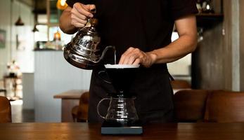 The barista is making coffee by dripping. photo