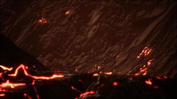 Red Orange vibrant Molten Lava flowing onto grey lavafield and glossy rocky land video