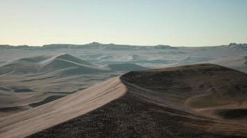 Aerial view on big sand dunes in Sahara desert at sunrise