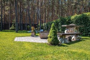 Iron fire pit with benches on stone pavement in garden backyard photo