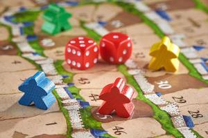 Board game with chips in the form of little men. Six dice were drawn on red dice. photo