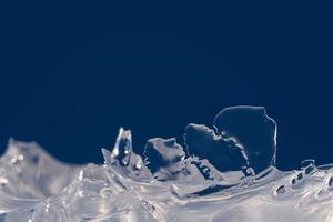 Ice close-up. Ice texture on a blue background. photo