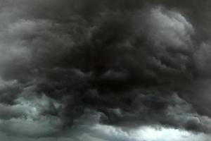 Danger storm clouds covering the sky with dark clouds. Ominous storm clouds.Storm clouds forming in the sky. photo