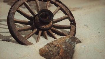 Large wooden wheel in the sand video