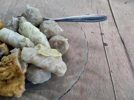 close up meatball on plate. with a wooden background. photo