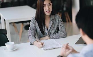 Job interview concept. Businessman questioning and listen to candidate answers during interview. photo