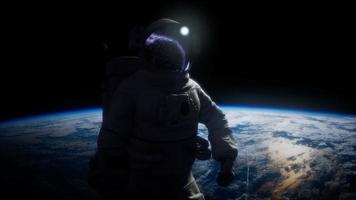 Astronaut in outer space against the backdrop of the planet earth video