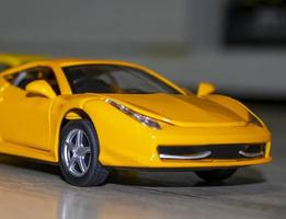 Toy cars. Children's Toy Plastic Yellow Car, Closeup. photo