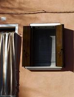 Window and door with wooden shutters.
