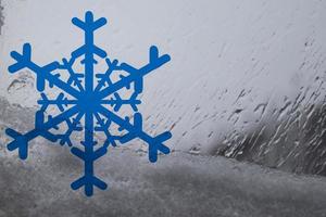 Christmas frosty snowflake pattern on the window glass. photo