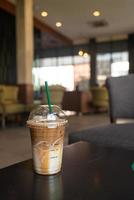 caramel macchiato coffee cup in coffee shop photo