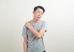 young Asian man having pain on neck or shoulder photo