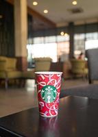 BANGKOK, THAILAND - Nov 24, 2021 - Starbucks hot beverage coffee with Christmas theme on the table. photo
