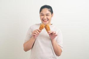 Asian woman with fried chicken on hand photo