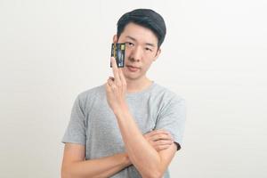 young Asian man holding credit card photo