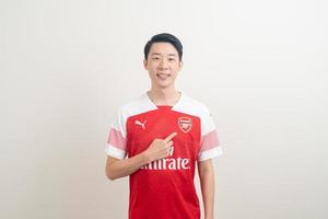 Bangkok, THAILAND - Nov 27, 2021 - Young Asian man wearing Arsenal shirt with white background. photo