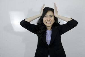 Business young asian girl is stress and confuse about her work isolated on white background photo