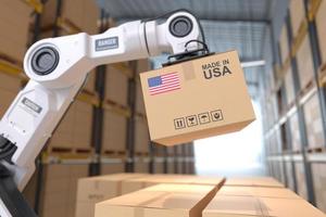 The Robot arm picks up the cardboard box Made in USA, Automation robot arm in the storehouse photo