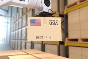 The Robot arm picks up the cardboard box Made in USA, Automation robot arm in the storehouse