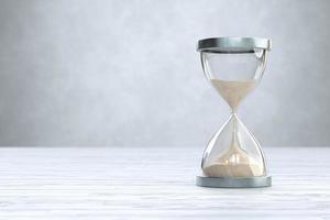 Hourglass on Wooden floor with copy space, sandglass photo